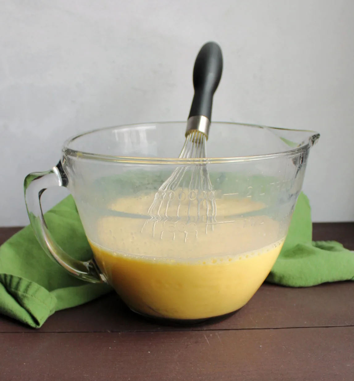 glass batter bowl filled with eggs and milk beaten together and whisk.