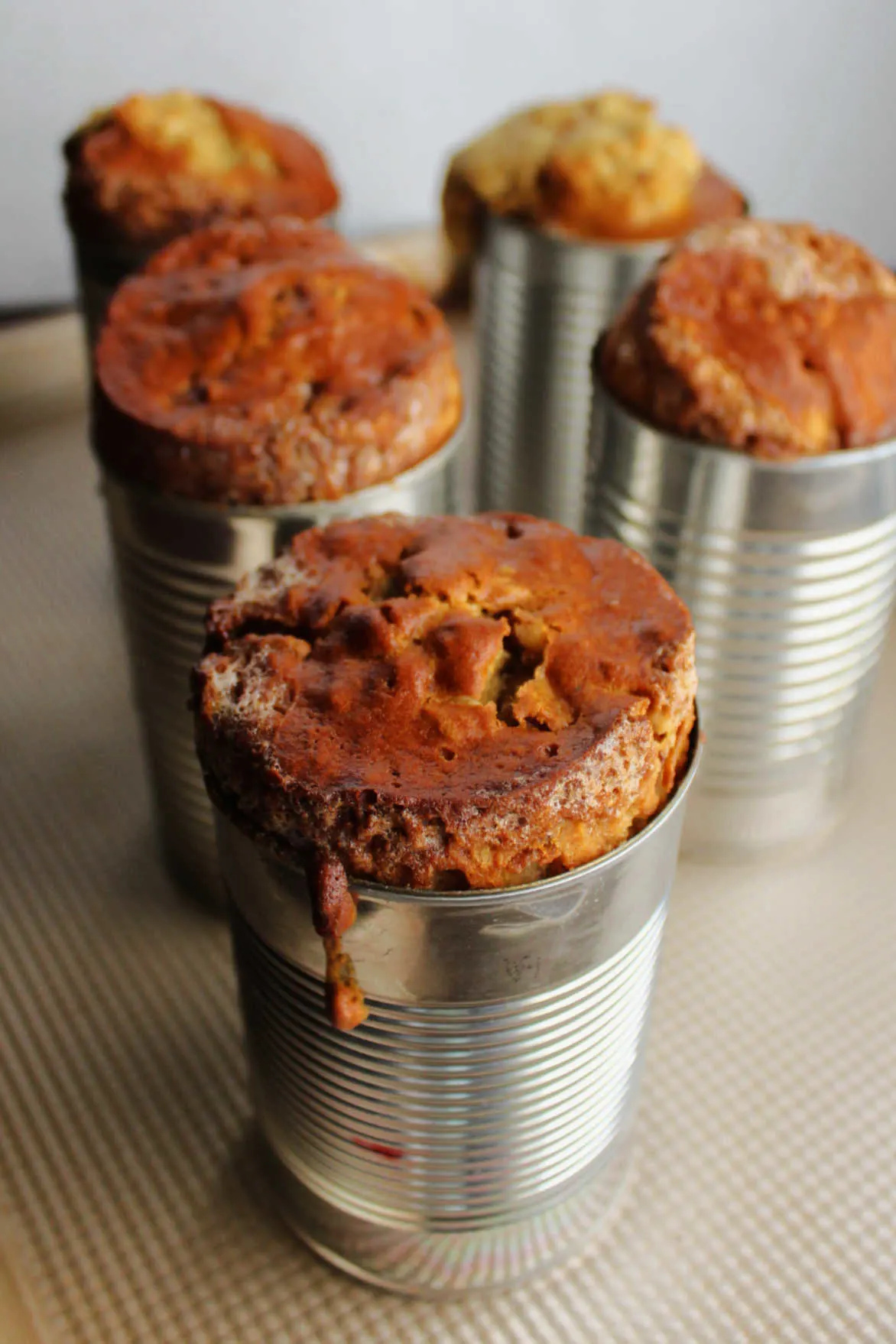 Date nut bread in cans fresh out of the oven.