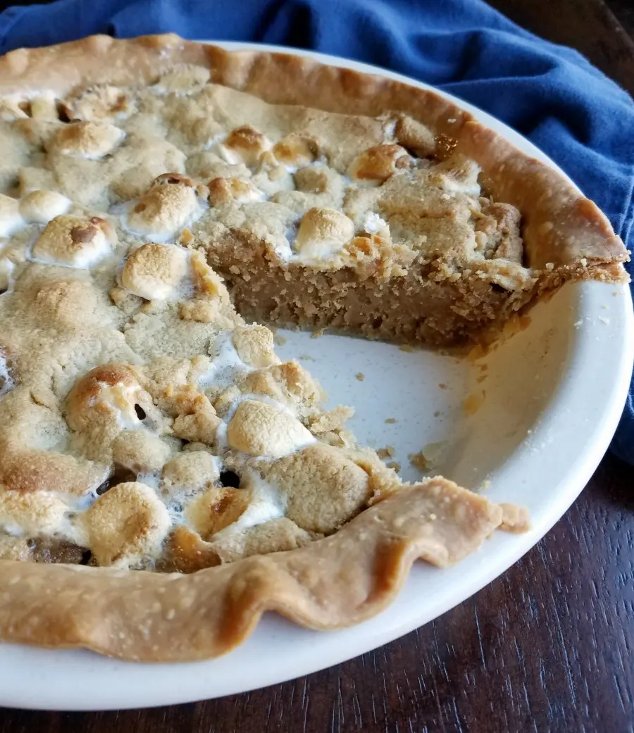 Fluffernutter cookie pie in pan with slice missing.