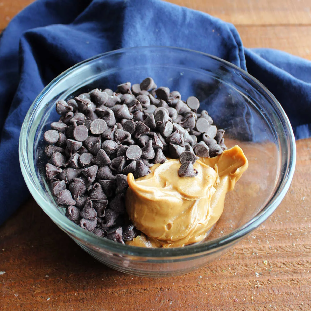 Bowl of peanut butter and chocolate chips ready to be made into topping for peanut butter bars.