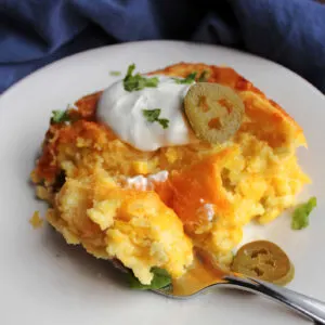 piece of chili cheese corn pudding topped with sour cream, cilantro and pickled jalapenos.