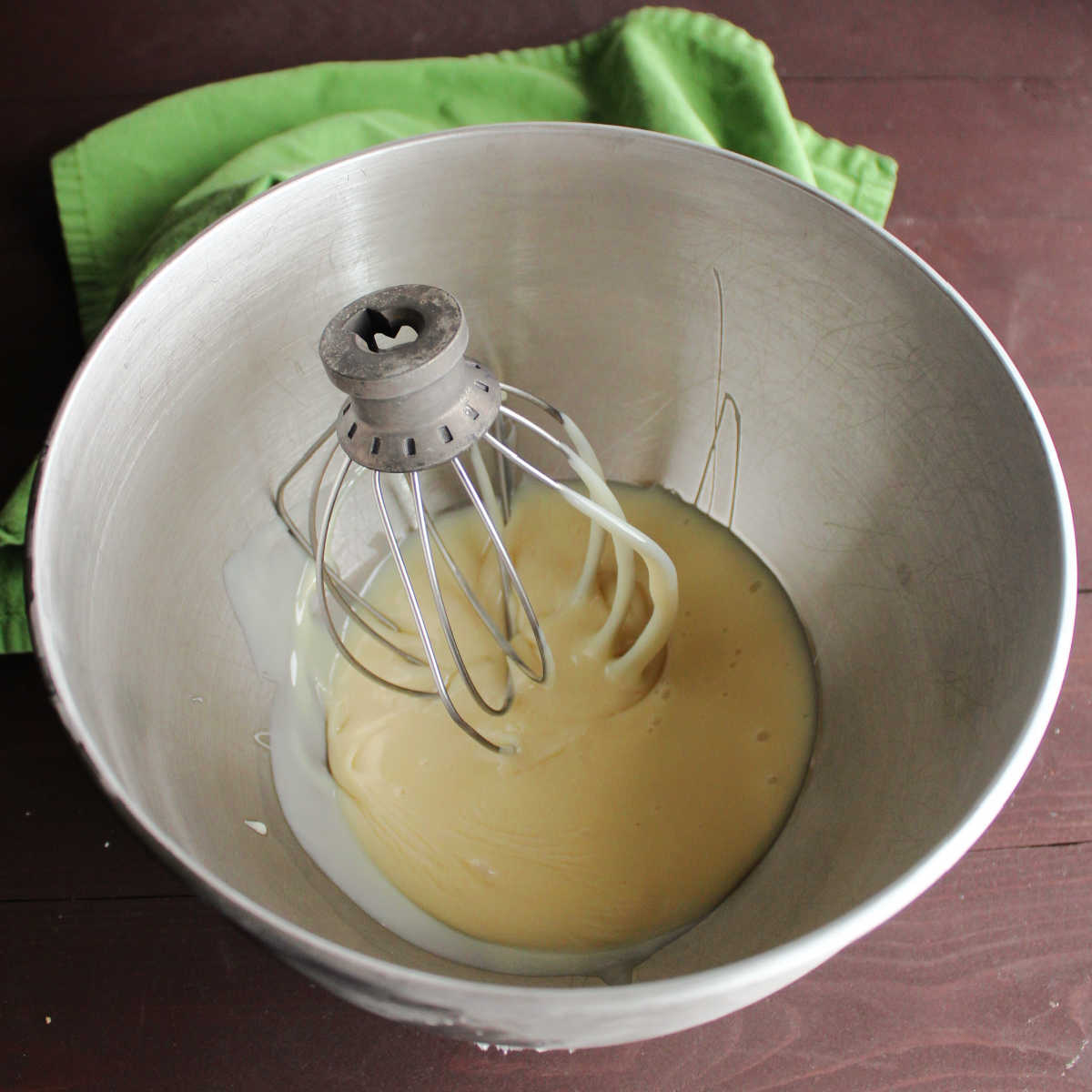 super cold sweetened condensed milk in mixer bowl, ready to whip.