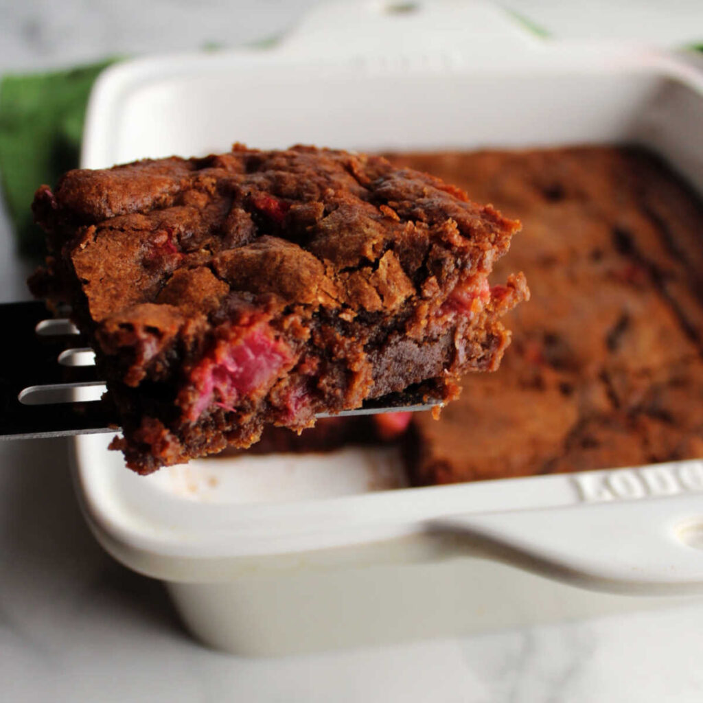 Lifting first slice of rhubarb brownies out of pan.