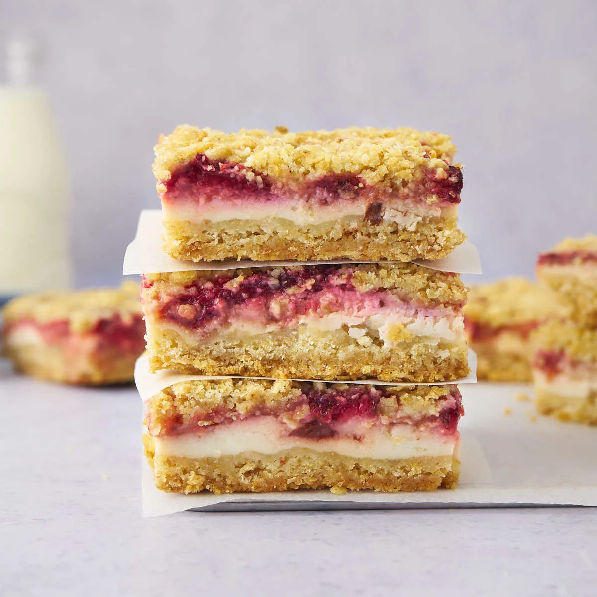 Stack of crumb bars with strawberries and yogurt in the middle.