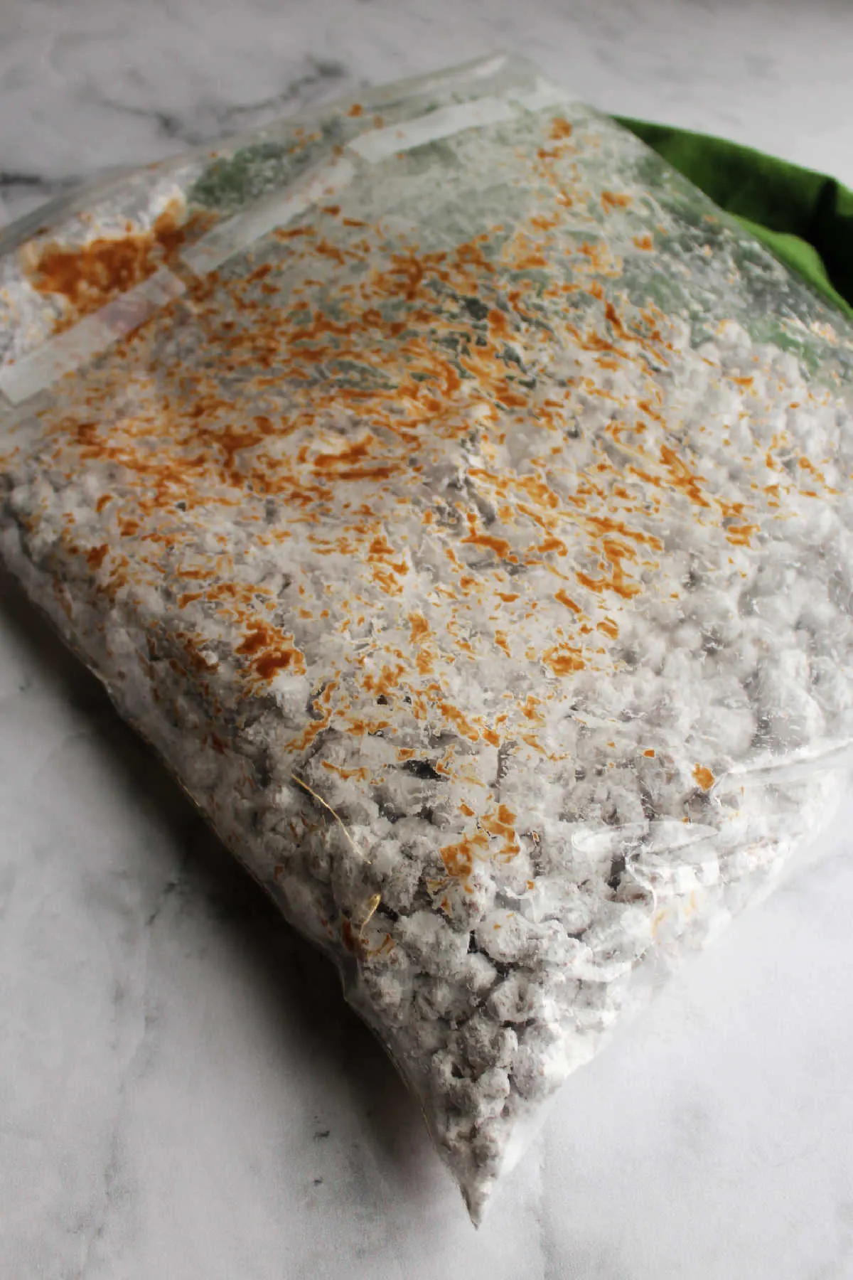 Big plastic bag with powdered sugar coated puppy chow popcorn.
