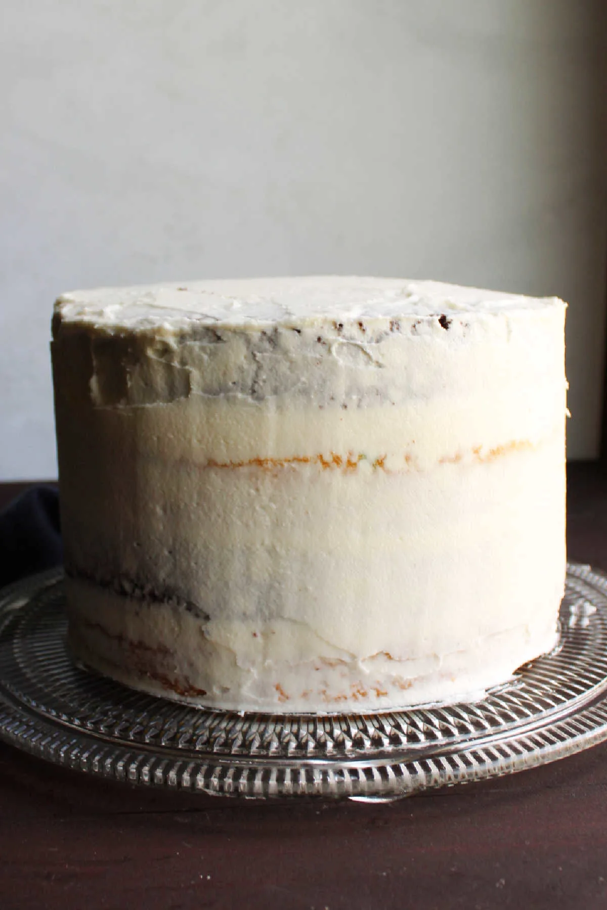 Layer cake with crumb coat of marshmallow buttercream.