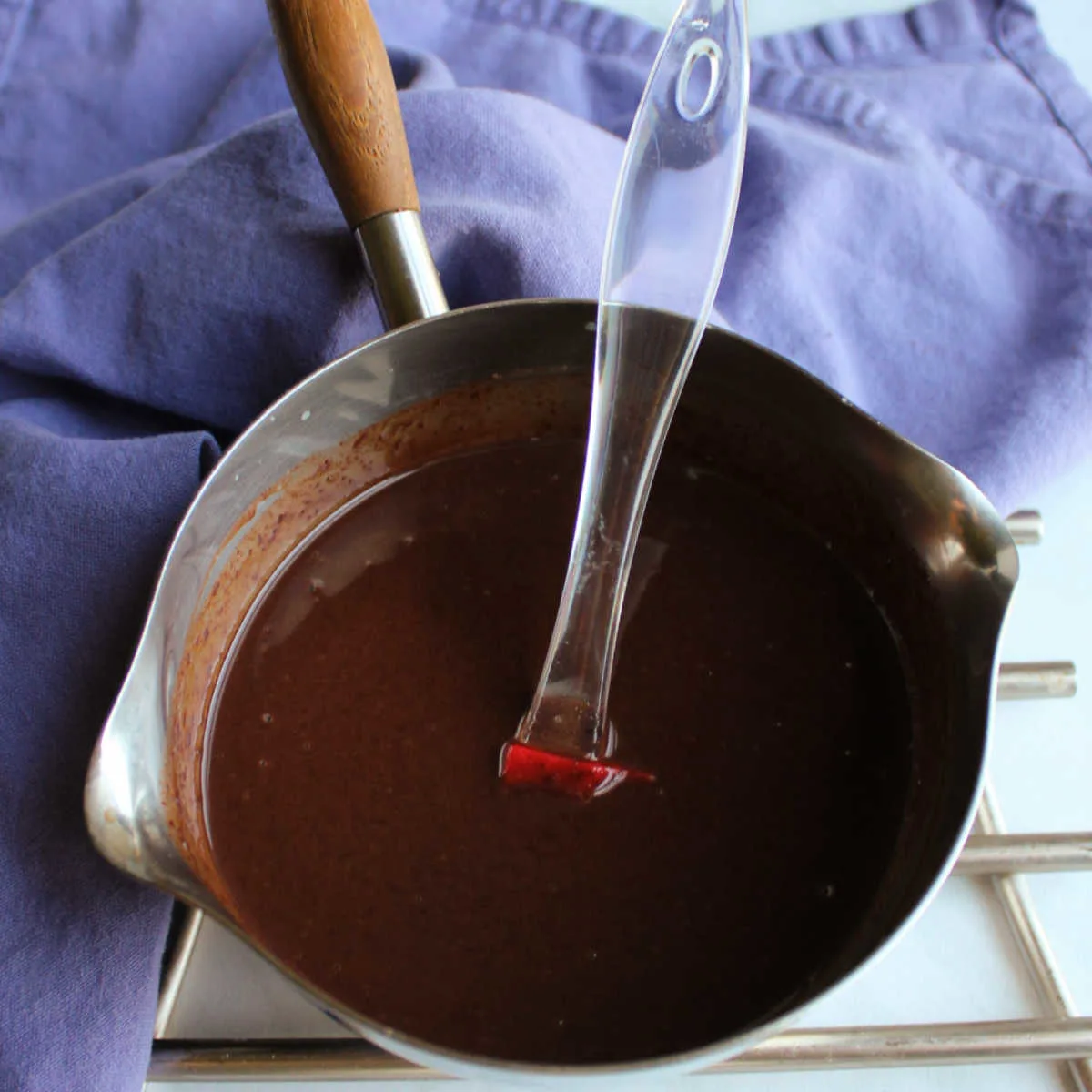 Rich chocolate glaze in saucepan, ready to use.