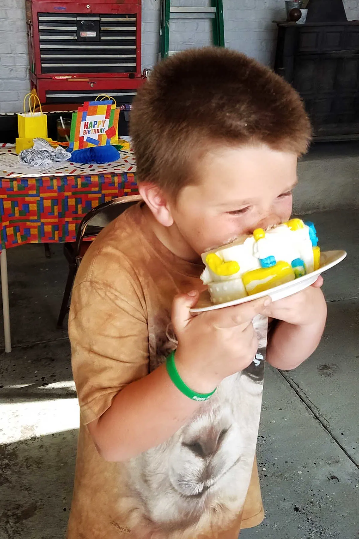 Boy putting his face into a cake.