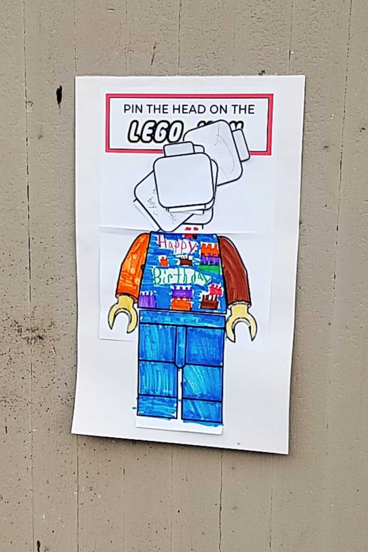 pin the head on the lego man poster.