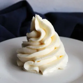 Piped swirl of fluffy white marshmallow buttercream frosting.
