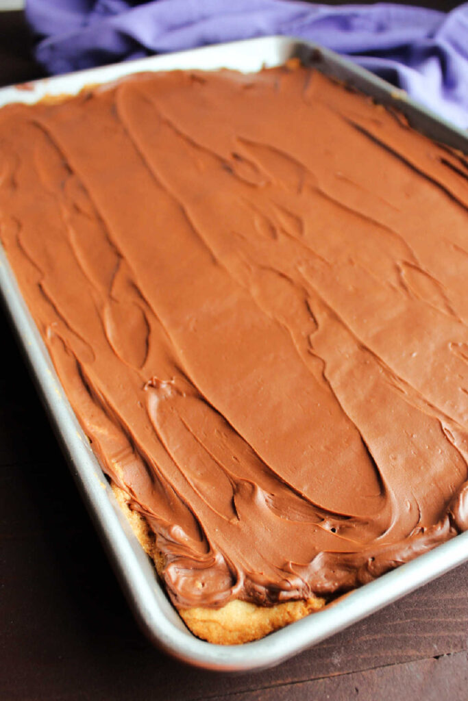 sheet pan filled with toffee bars with chocolate spread over the top.