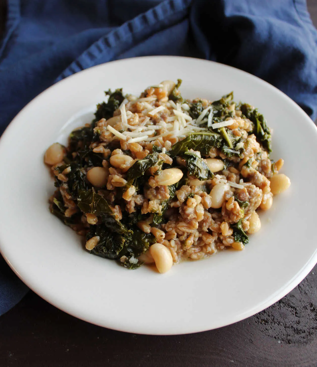 Plate of one pot farro with kale and Italian sausage.