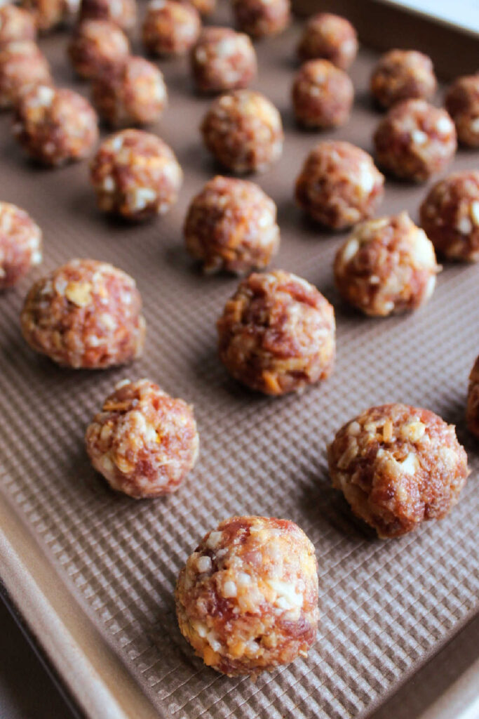 Sheet pan filled with breakfast sausage meatballs.