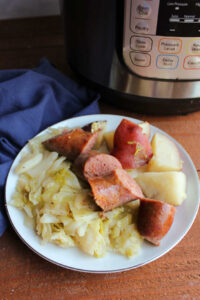 plate of keilbasa with potatoes and cabbage by instant pot.