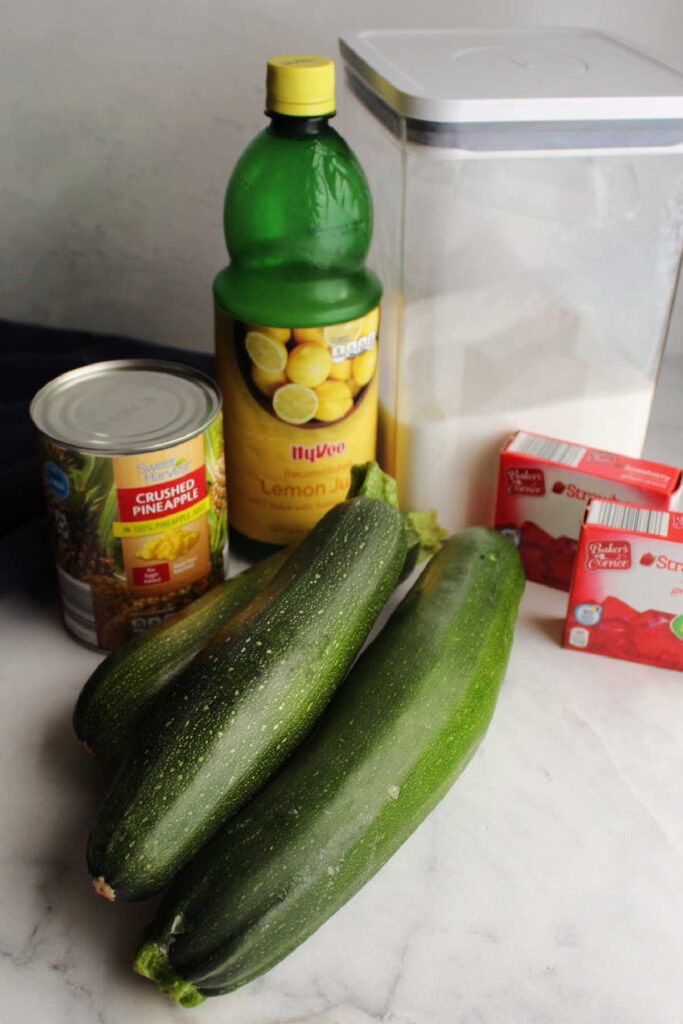 zucchini jam ingredients with sugar, a can of pineapple, lemon juice and jello.
