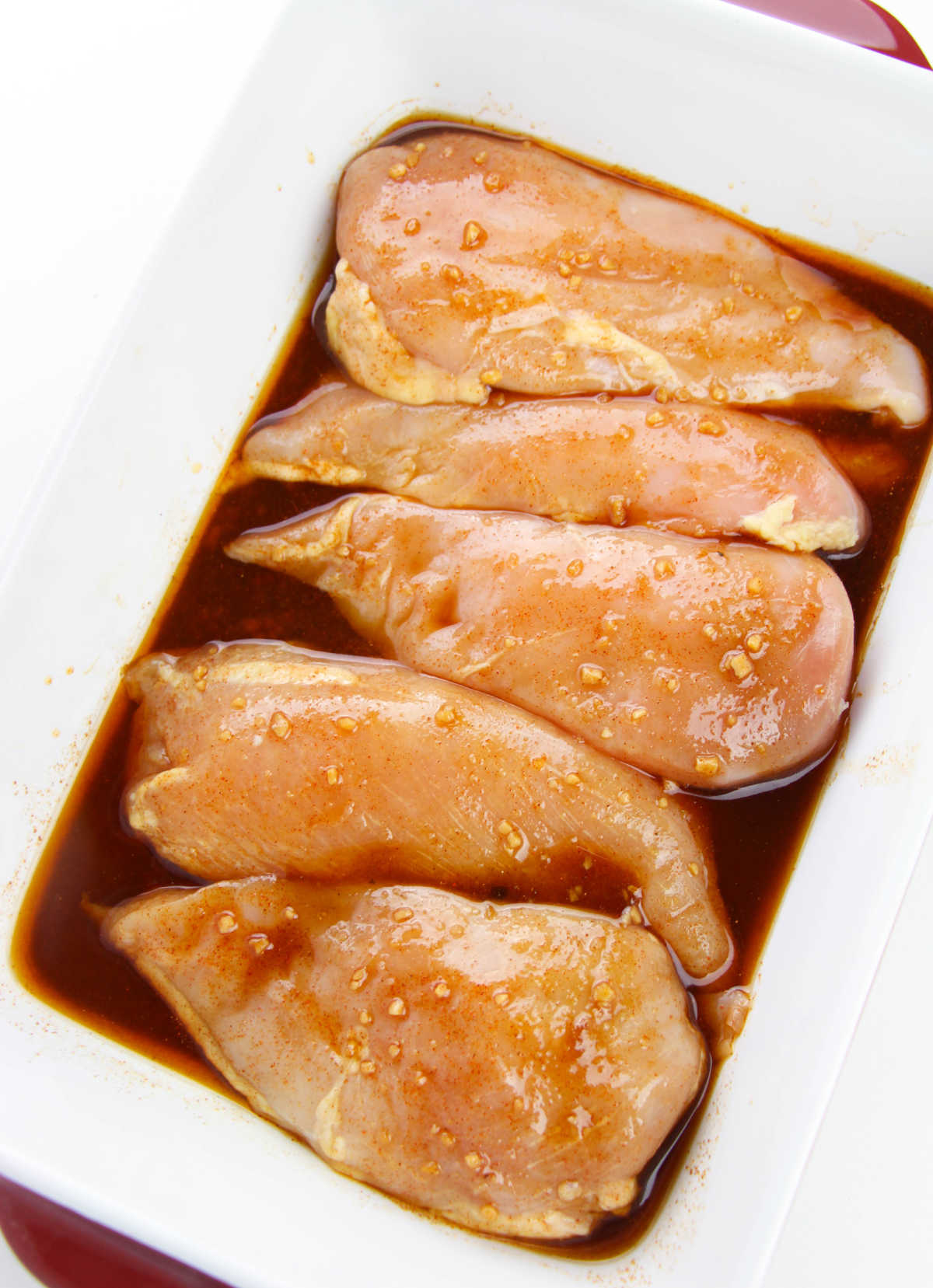 Chicken soaking in marinade.
