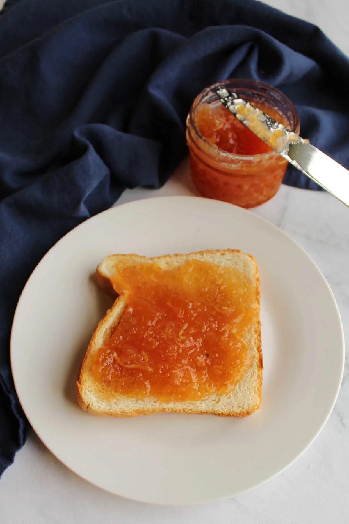 strawberry zucchini jam spread over slice of toast.
