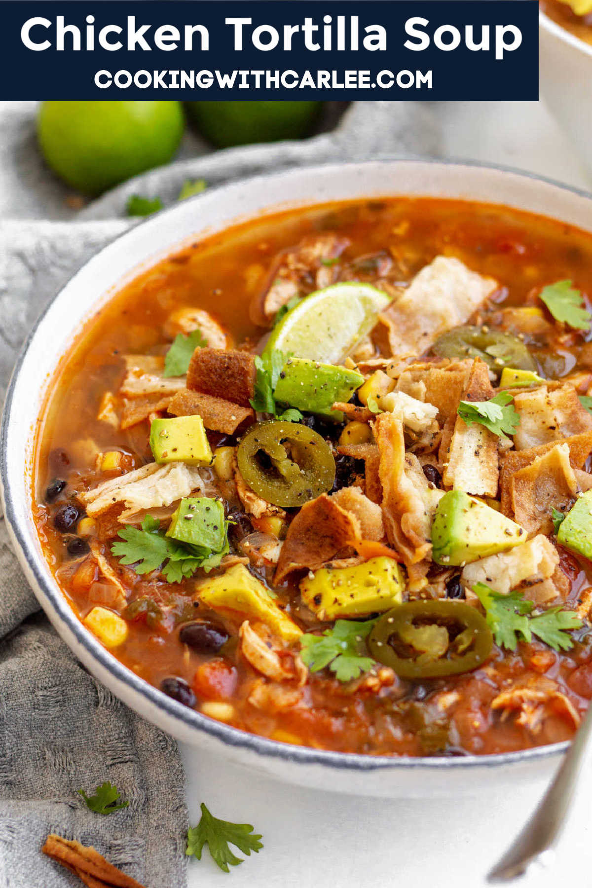 Chicken Tortilla Soup is a cozy & filling soup recipe full of shredded chicken, corn, beans and other delicious ingredients that are simmered in a tomato base. Top the soup generously with homemade tortilla chips, cilantro, avocado, lime and a dollop of sour cream and you got yourself a perfect Mexican-inspired soup which is the perfect easy weeknight dinner.