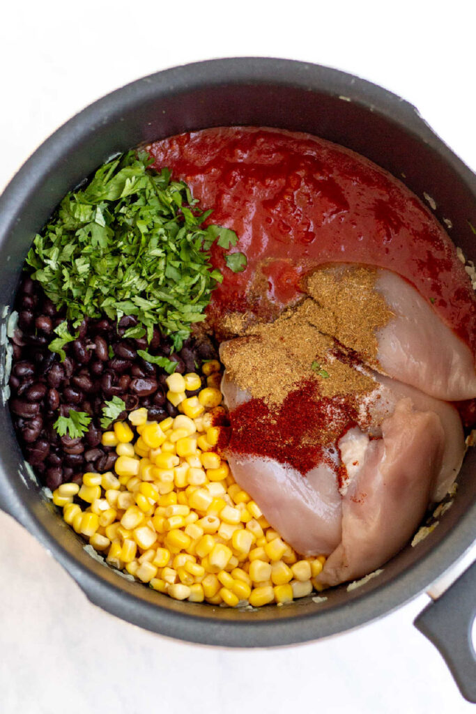 chicken, tomatoes, black beans, corn and tomatoes added to pot.