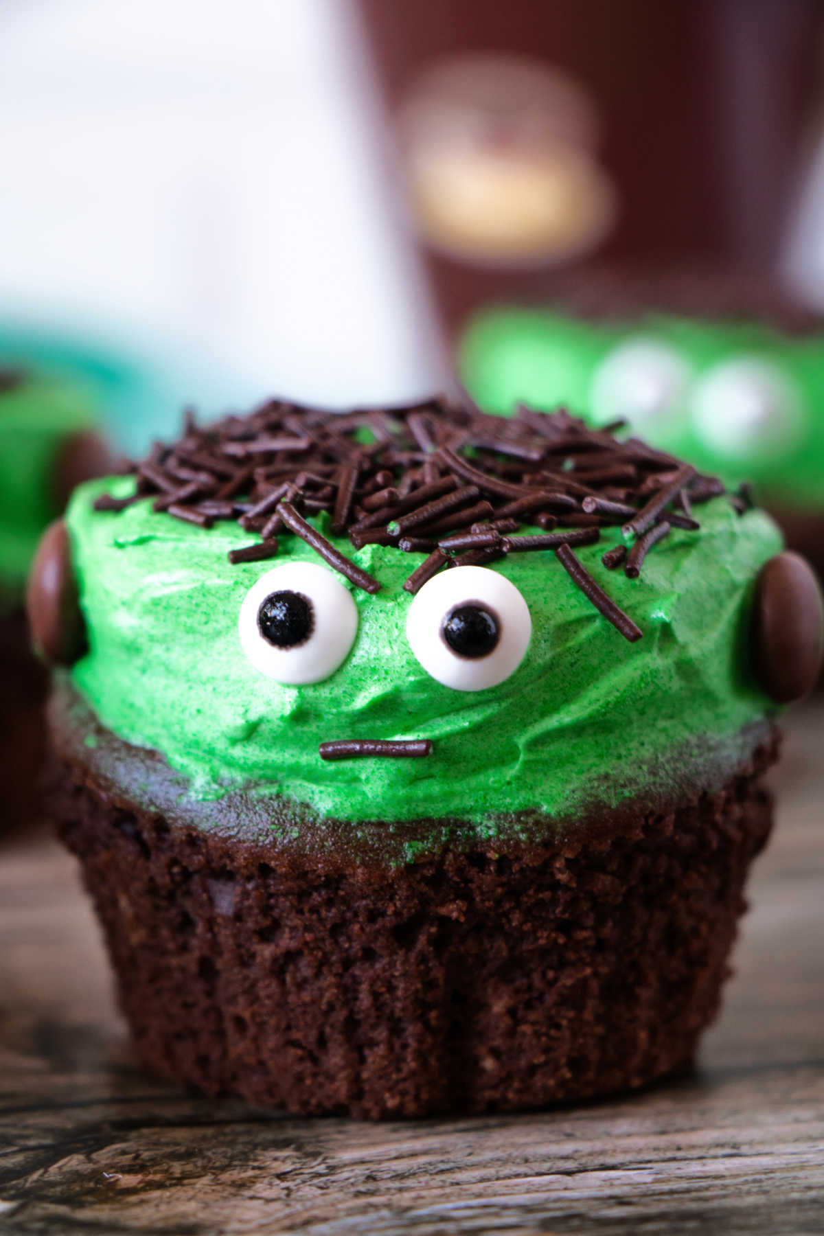 Cute Frankenstein cupcake with chocolate sprinkle hair and candy eyes.
