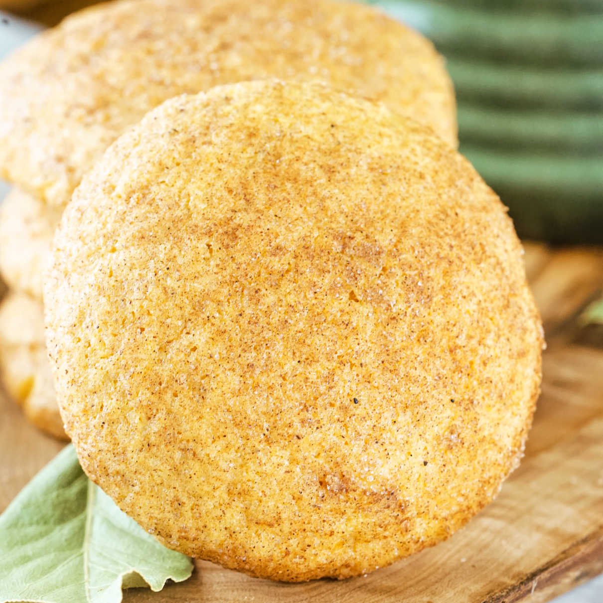Close up of a soft pumpkin snickerdoodle cookie with cinnamon sugar dusting on the outside.