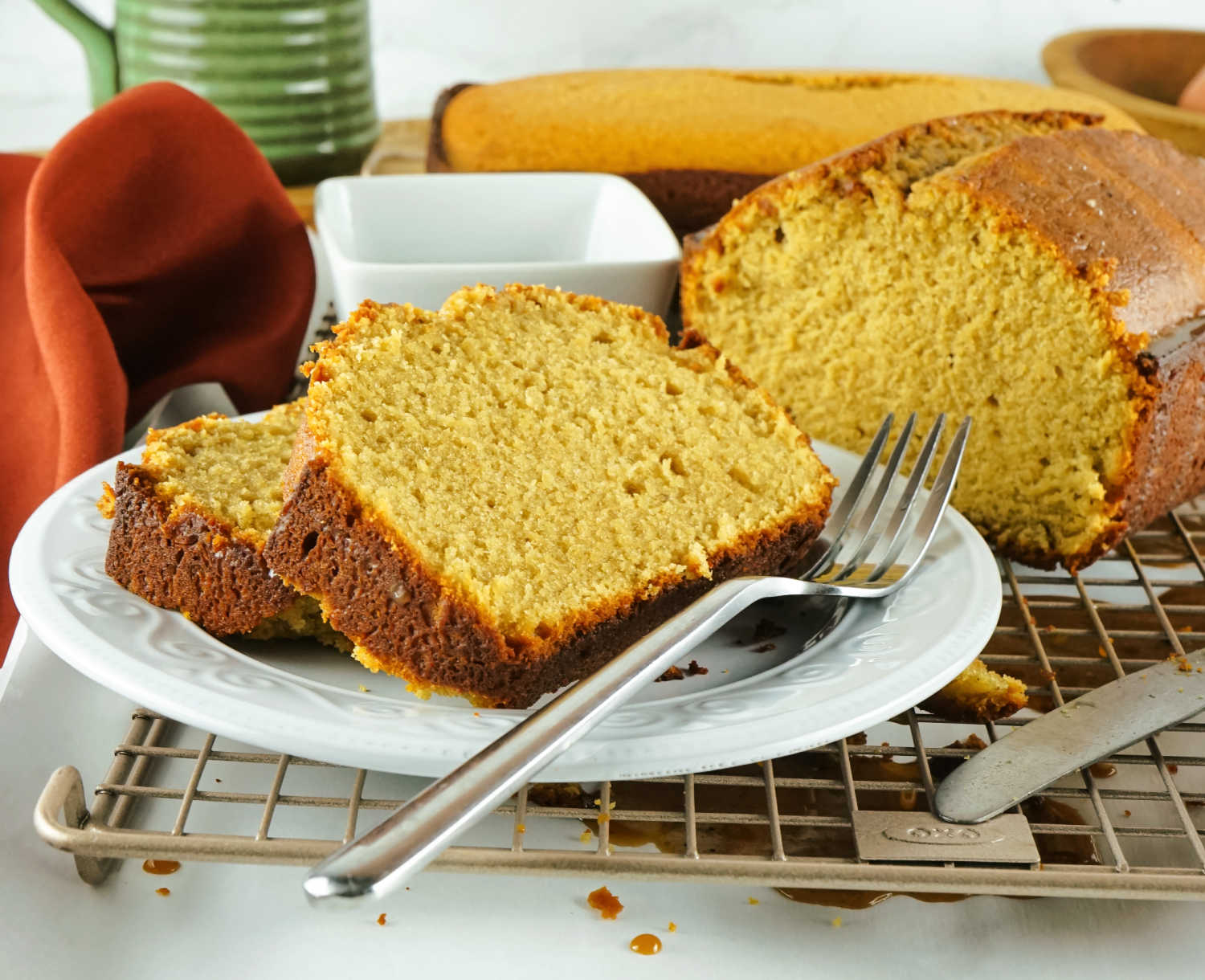 Slices of loaf shaped coffee flavored pound cake on plate with fork.