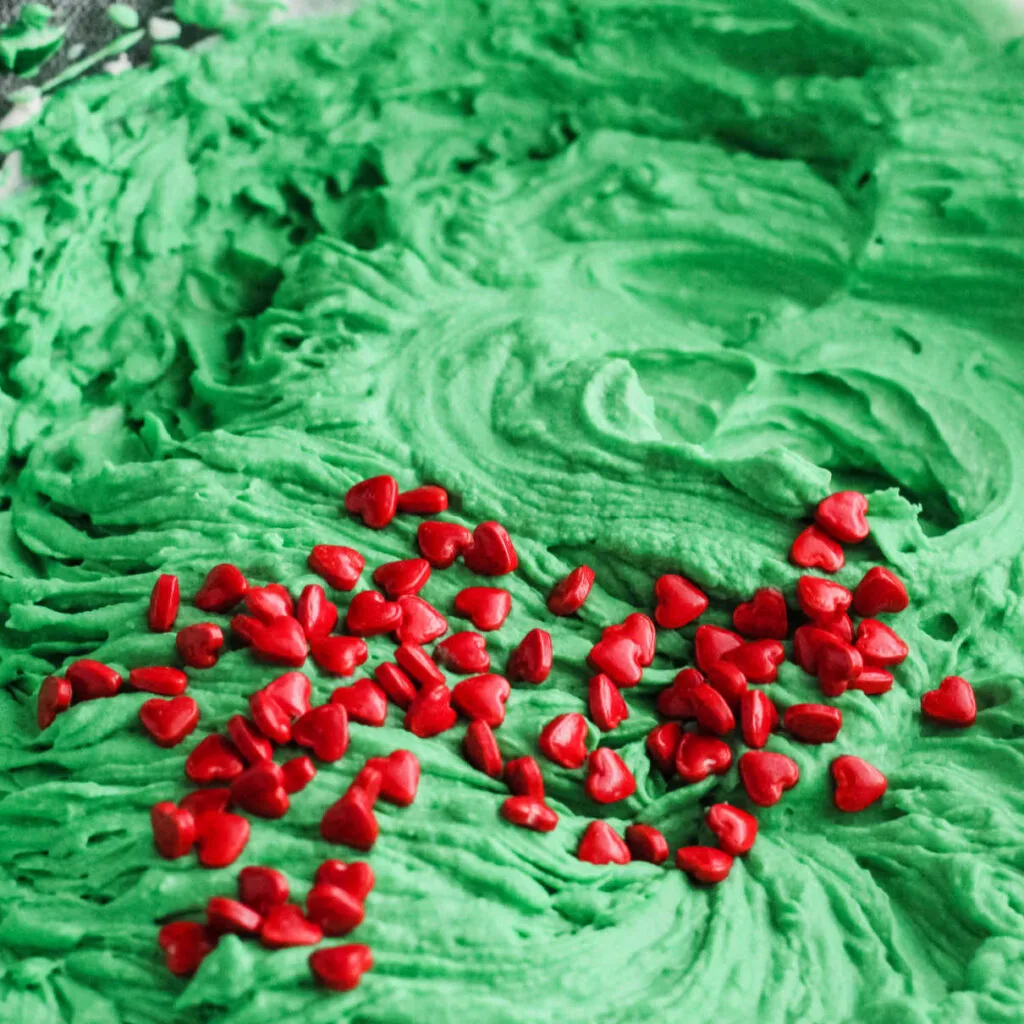 red candy hearts sprinkled over green ice cream base. 