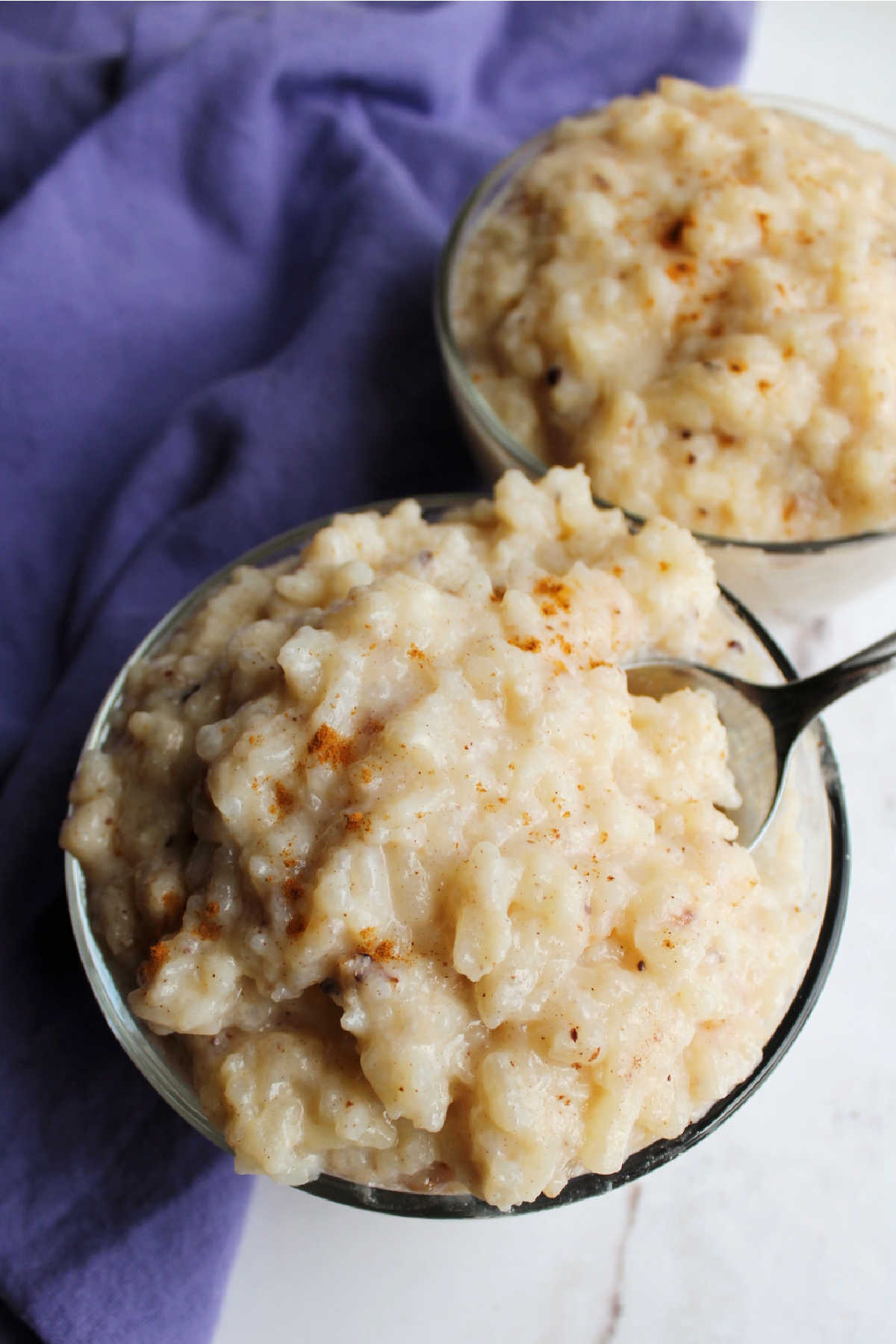 Close bowl of creamy rice pudding with freshly grated nutmeg on top.