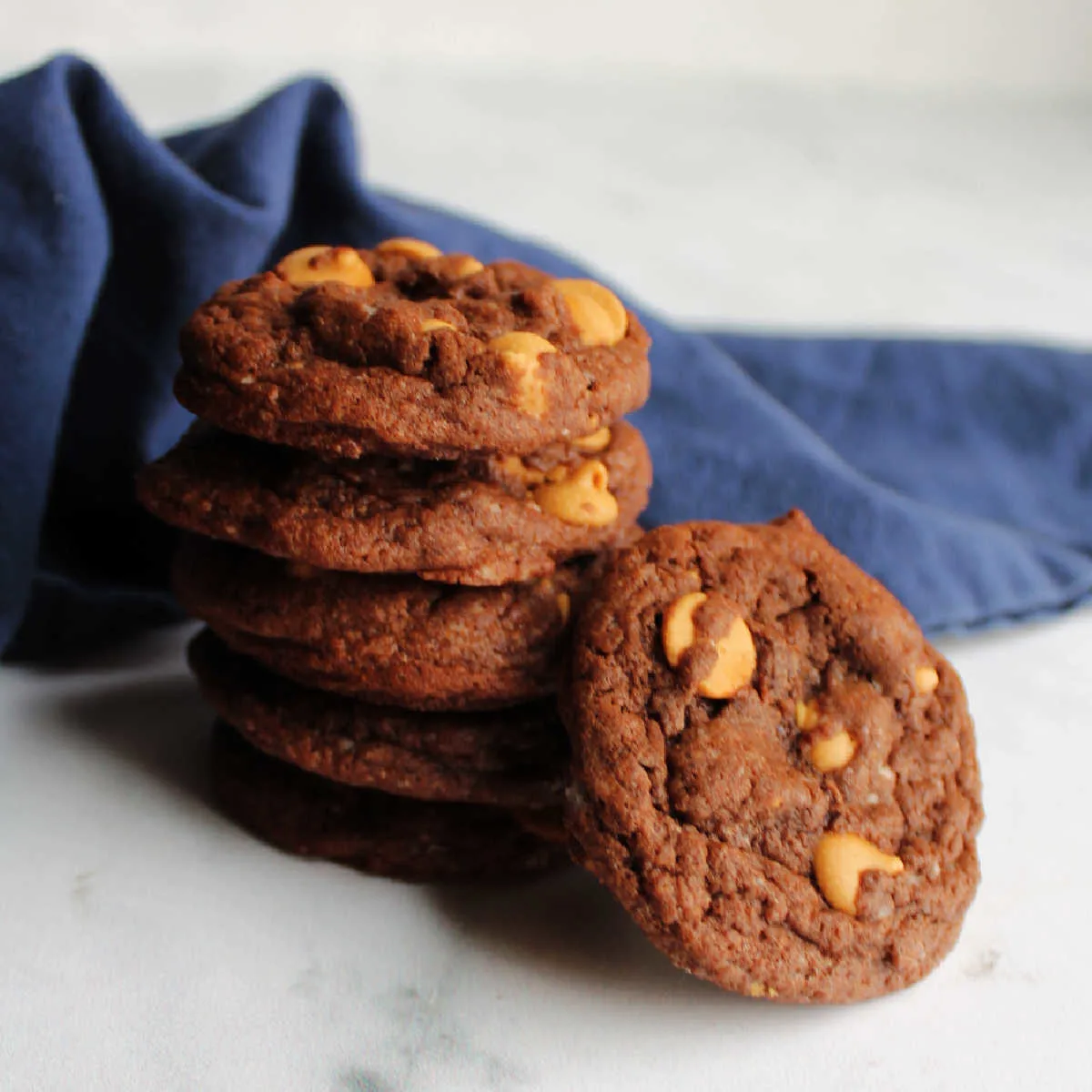 Stack of chocolate cookies with peanut butter chips.
