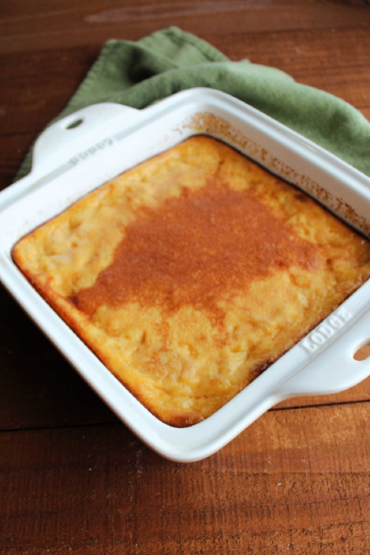 Pan of freshly baked rice pudding with layer of cinnamon on top.
