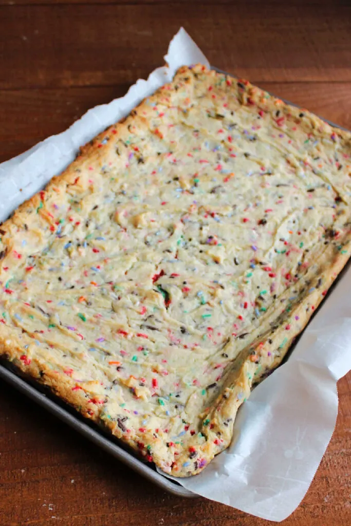 Freshly baked sprinkle filled sugar cookie bars with lightly golden edges.
