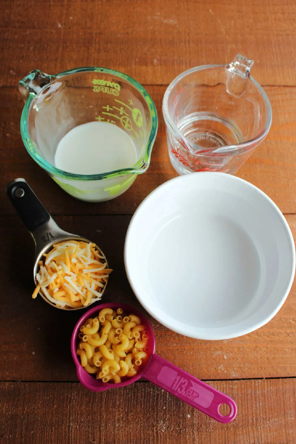 Milk, pasta and cheese ready to be made into easy mac, ingredient shot.