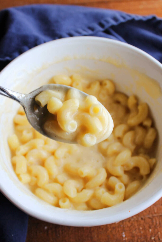 Spoonful of creamy single serve microwave macaroni and cheese.