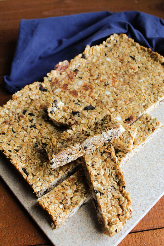Stack of homemade granola bars on cutting board.