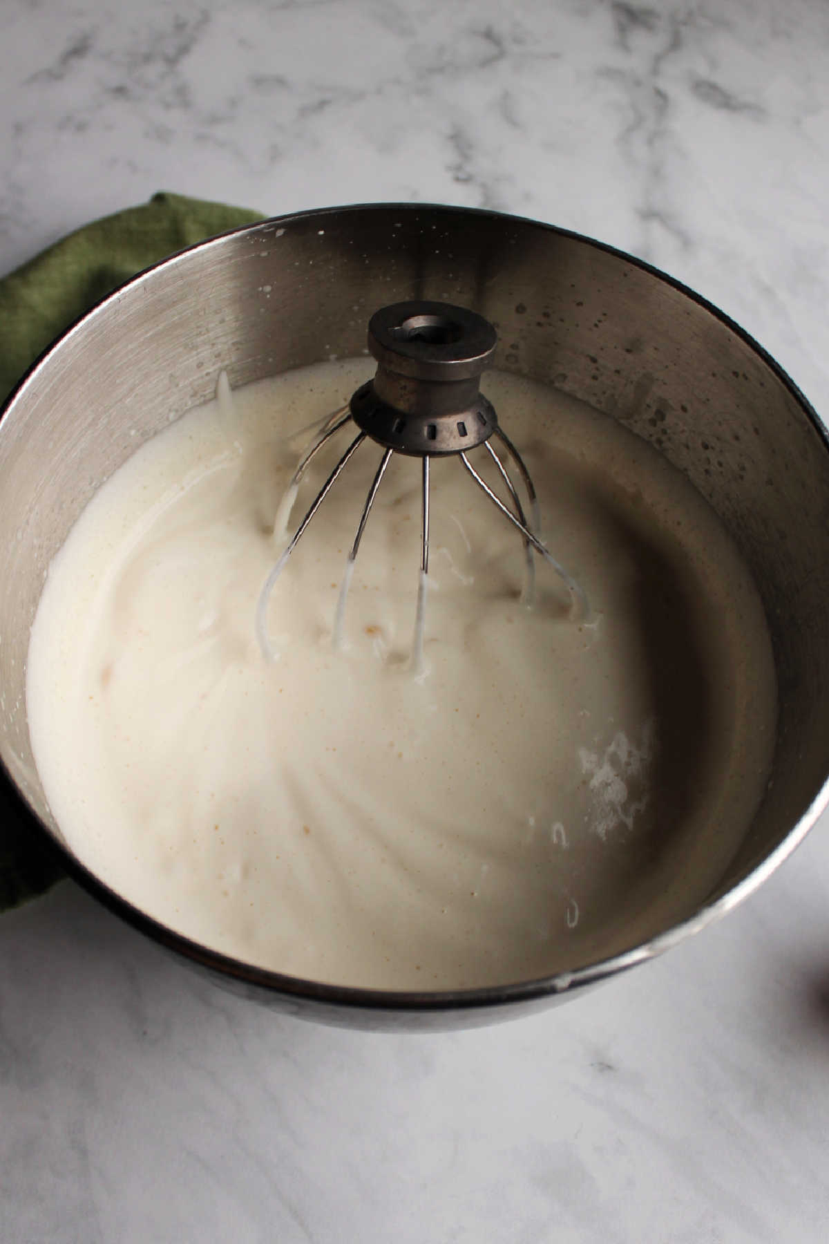 Bowl of whipped evaporated milk ready to top desserts.