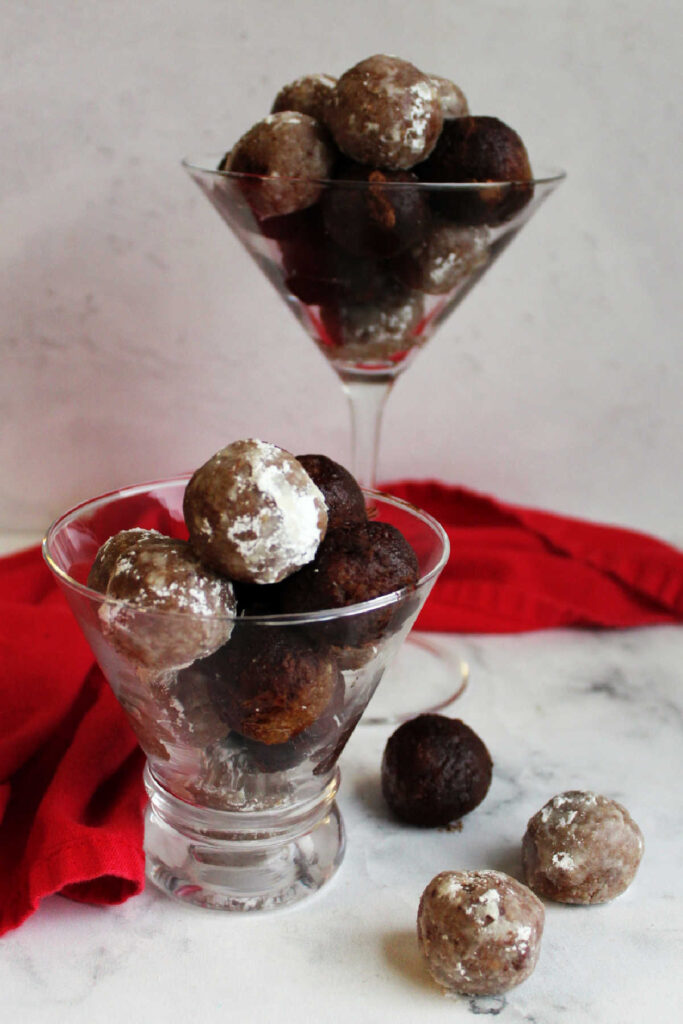 Martini glasses filled with pecan bourbon balls ready to eat.