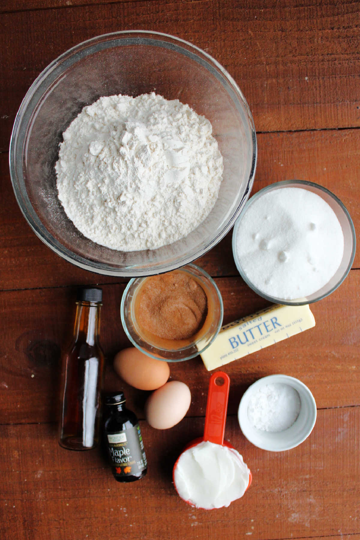 Ingredients including sugar, flour, butter, shortening, eggs, baking soda, cream of tartar, vanilla extract and maple extract ready to be made into maple snickerdoodle dough.