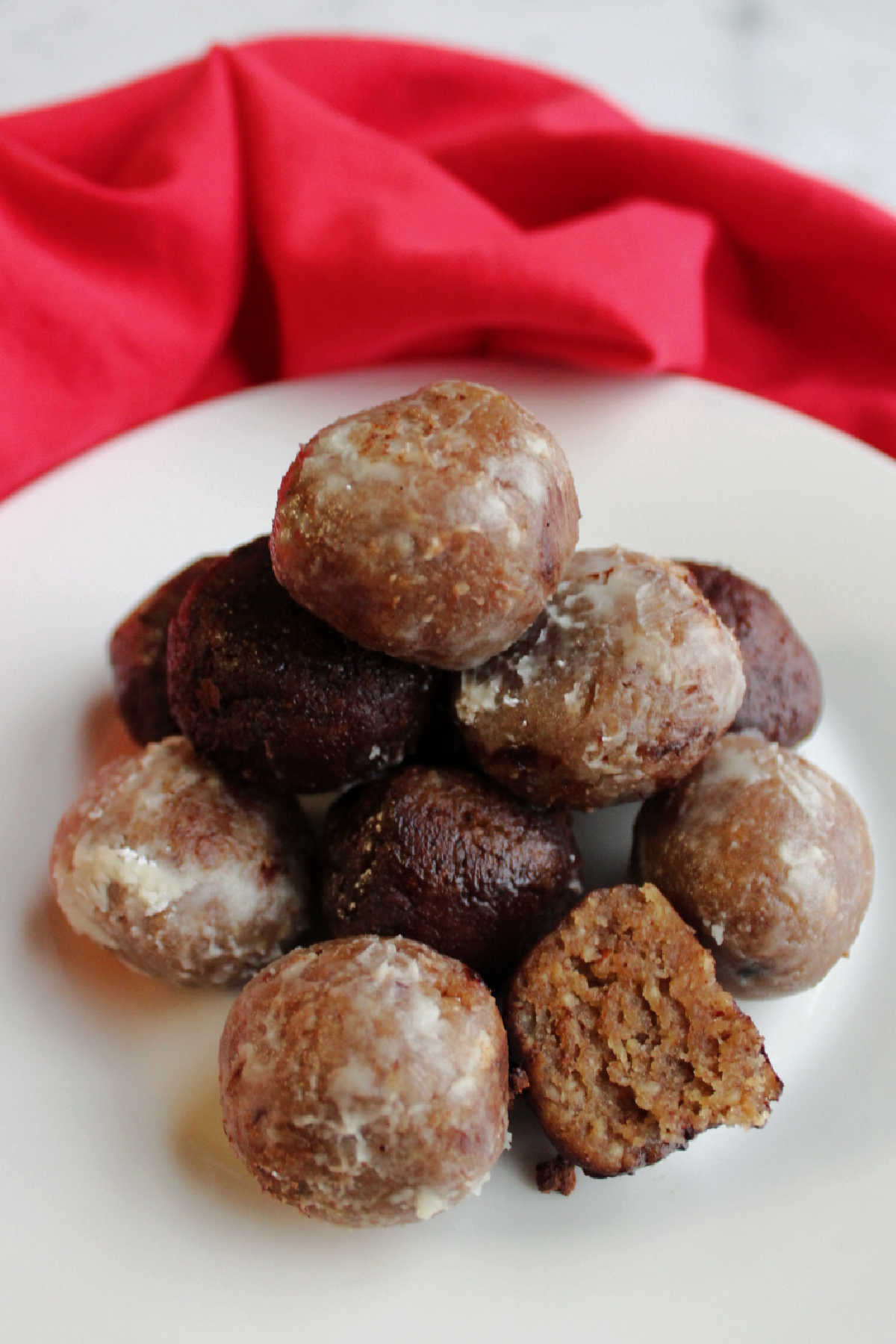 Stack of bourbon balls with one cut in half showing the center.