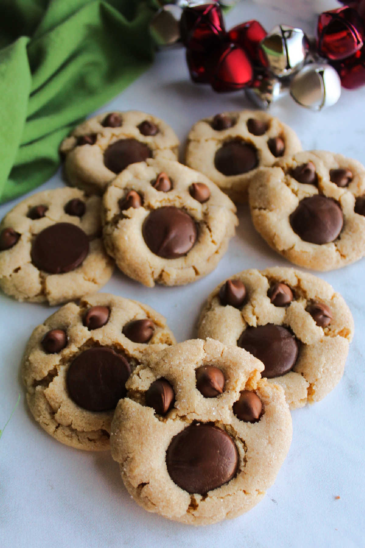 Freshly baked peanut butter bear paw cookies with chocolate decorations ready to eat.