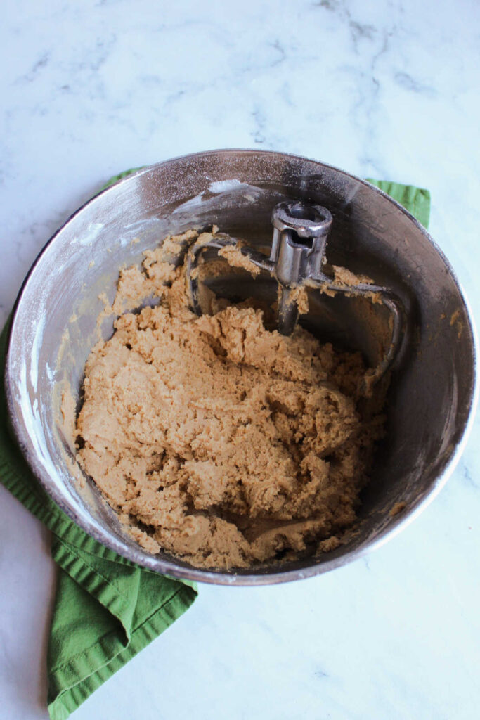 Mixer bowl filled with peanut butter cookie dough.
