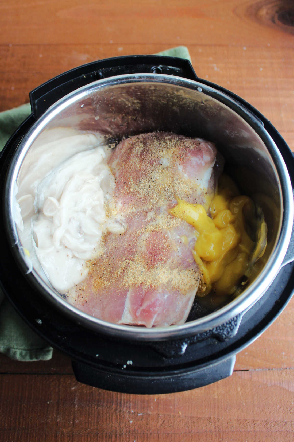 Pork loin, soups and seasoning in slow cooker.