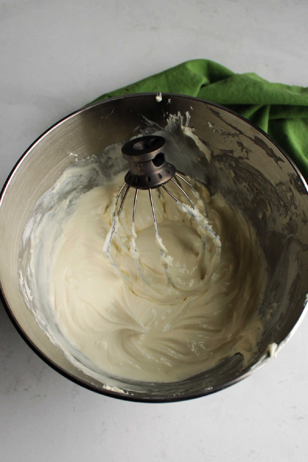 Mixing bowl filled with condensed milk no bake cheesecake mixture ready to be put in crust.