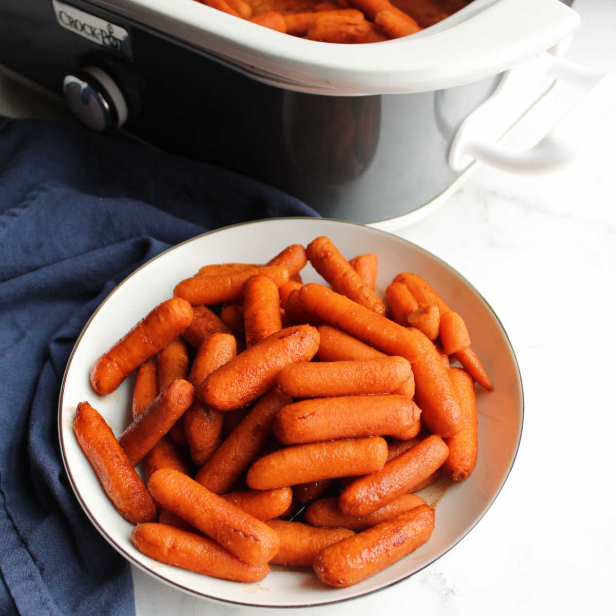 Serving bowl filled with carrots glazed in honey and cinnamon.