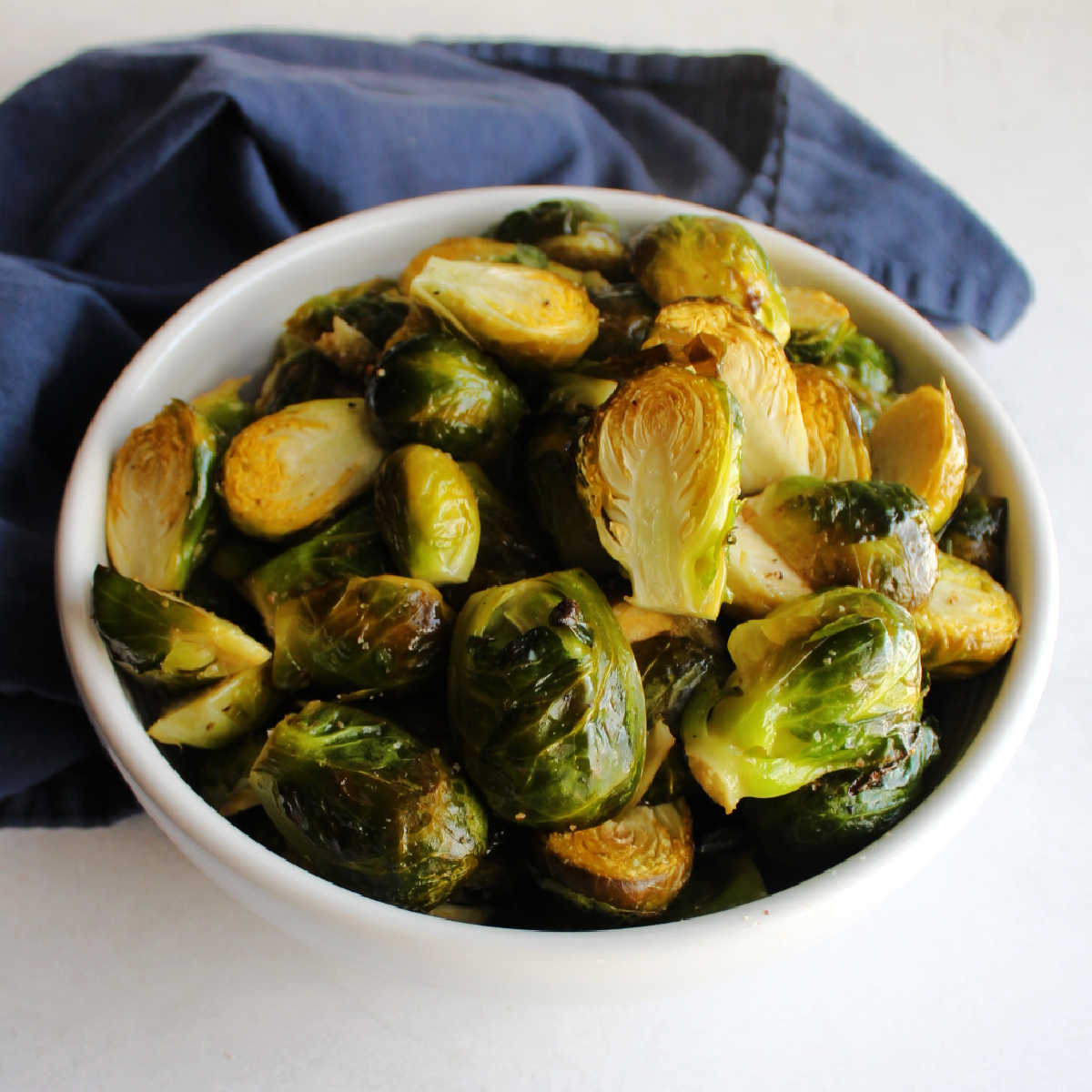 Bowl of roasted brussels sprout halves ready to serve.