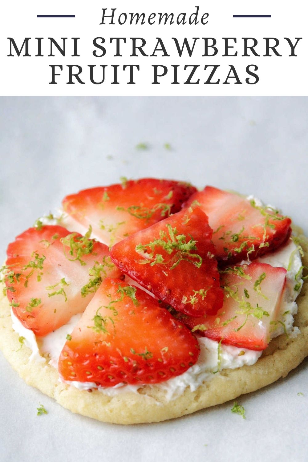 Mini strawberry fruit pizzas are built on chewy homemade sugar cookies. Top them with a slightly sweet cream cheese spread, fresh berries and an optional pop of lime zest for a super tasty treat.