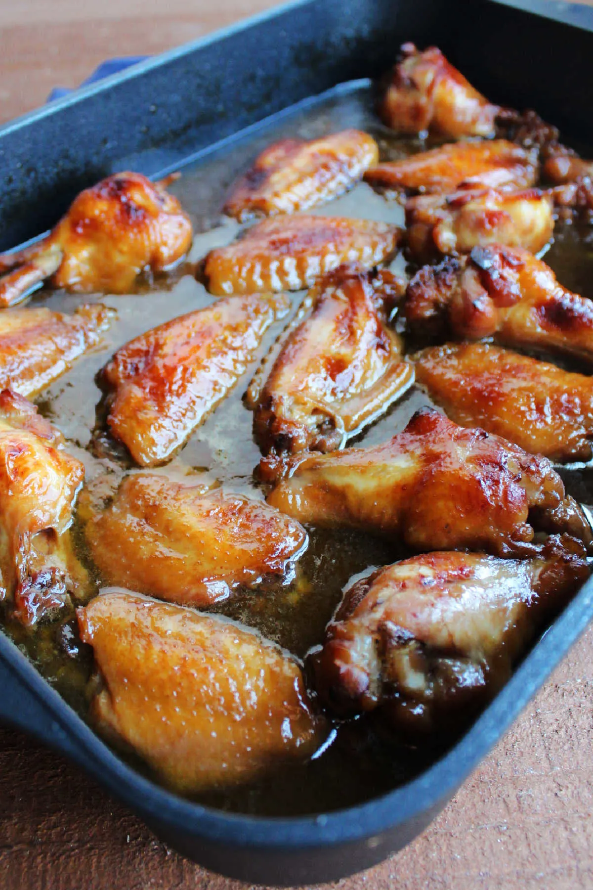 Pan filled with sticky baked wings fresh from the oven.