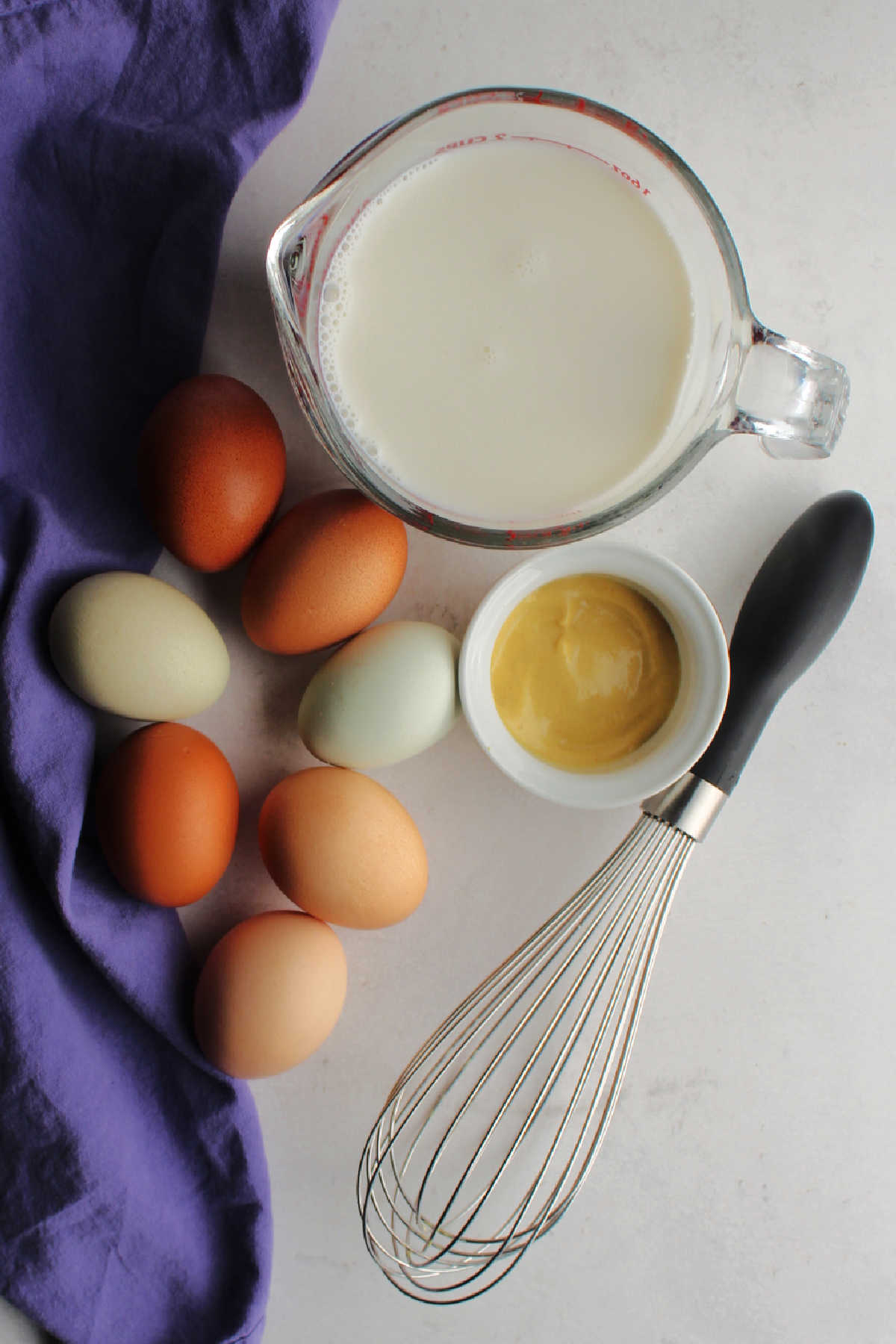 Eggs, milk and mustard ready to be made into custard.