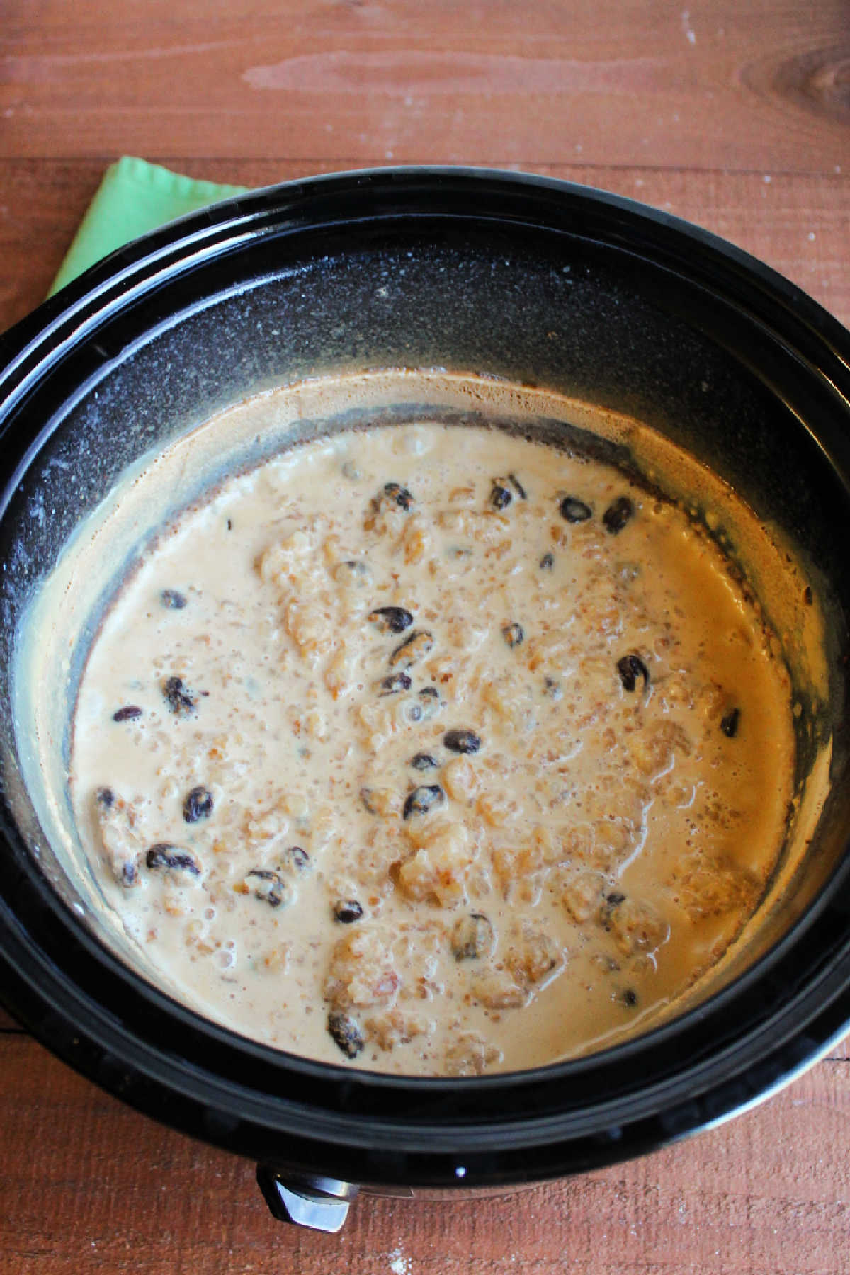 Cooked rice pudding in slow cooker with most of the milk absorbed.