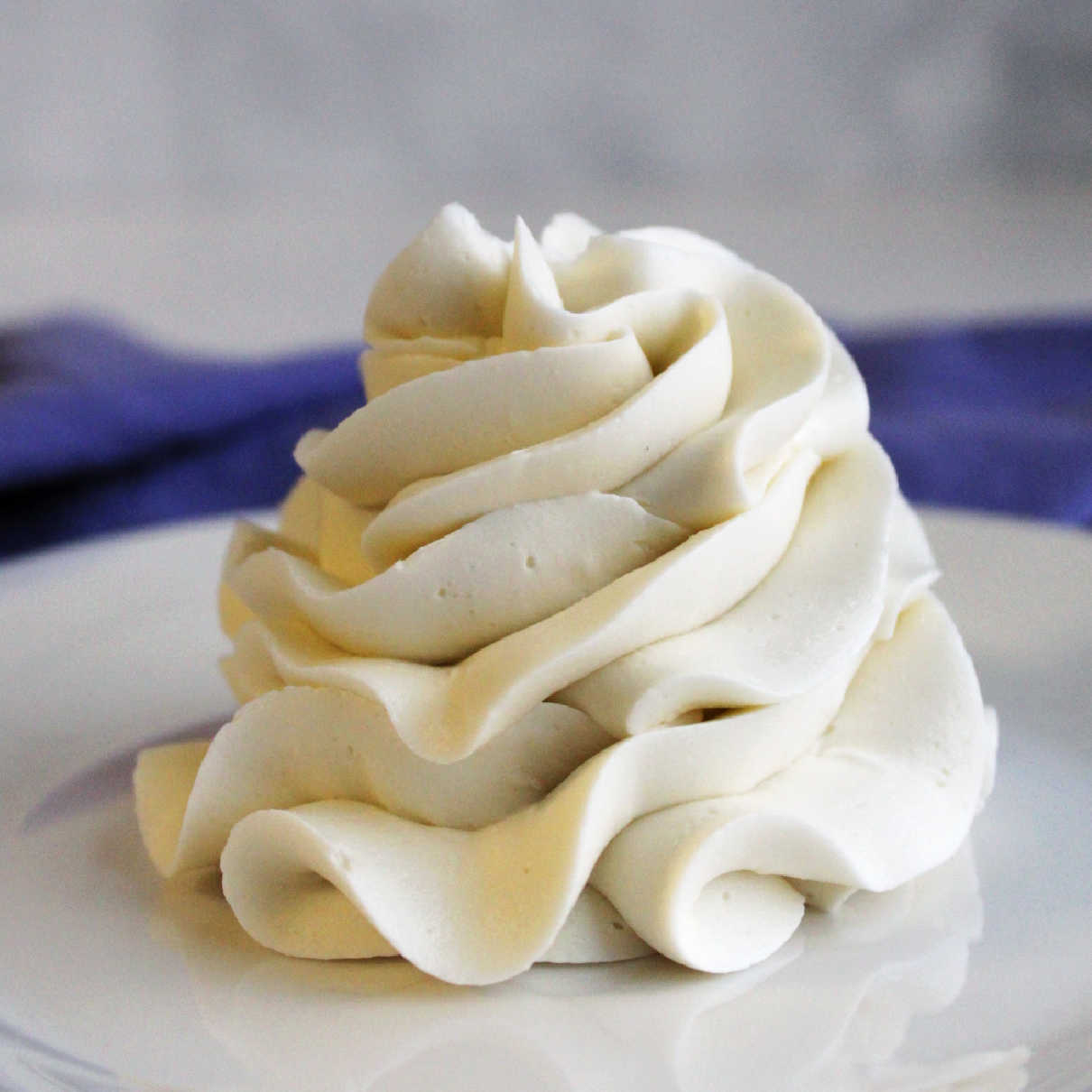 Ruffled swirl of white faux swiss meringue buttercream frosting.