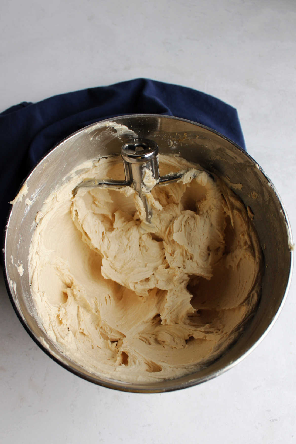 Mixing bowl filled with fluffy brown sugar buttercream.